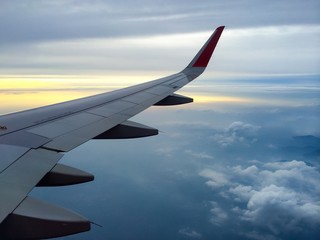 Fototapeta premium Wind of the plane with cloudy sky on background at sunset