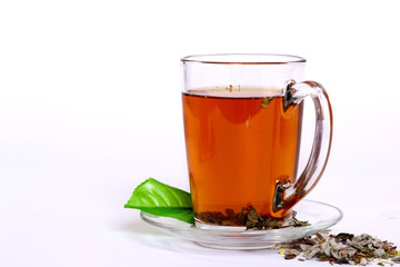 Cup of fresh herbal tea on white