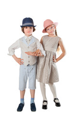Stylish boy and girl hand by hand in studio