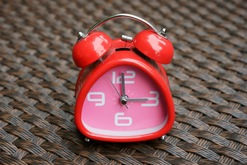red clock on weave background