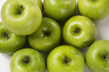 Some green apples on a white background
