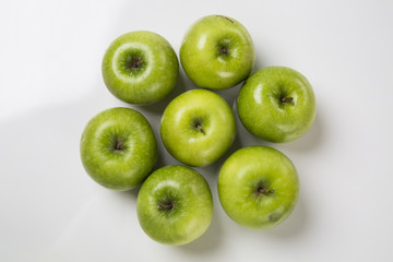 Some green apples on a white background