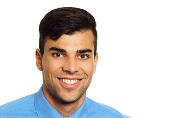 Fototapeta premium Portrait of young smiling businessman in blue shirt, right you can write some text