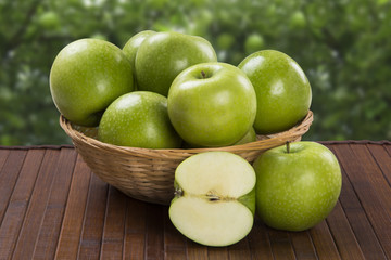 Some green apples on a wooden table