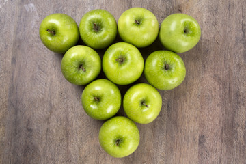 Fototapeta na wymiar Some green apples on a wooden table