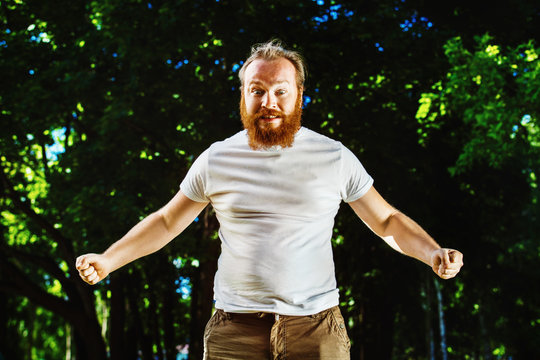 Portrait Of Young Angry Man With Red Hair And Beard 