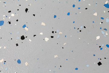 Sparse flecks in grey epoxy shop floor sealant