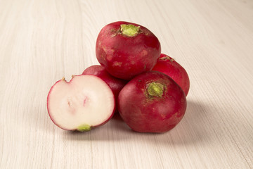 Some radishes in a basket over a white background