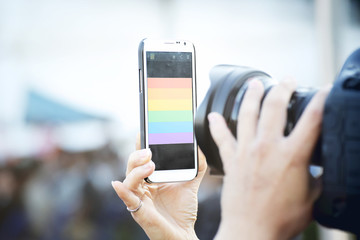 Selfie with rainbow flag symbol of gay pride.Symbolizing gay love