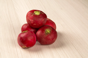 Some radishes in a basket over a white background
