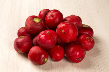 Some radishes in a basket over a white background
