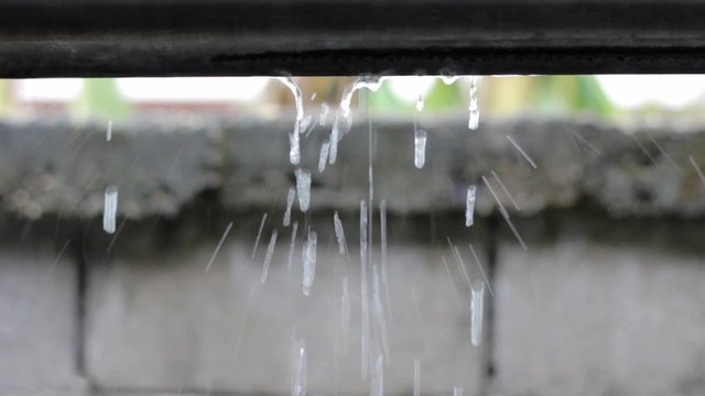 Rain dropping and dripping on house roof