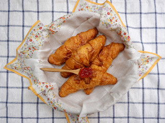 Croissants in the basket with flower pattern napkin