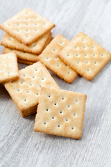Stack of square crackers on wooden table