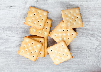 Stack of square crackers on wooden table