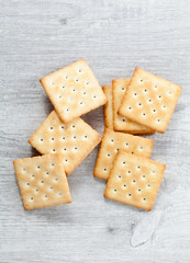 Stack of square crackers on wooden table