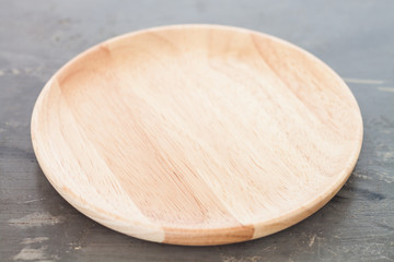 Wooden plate on gray background