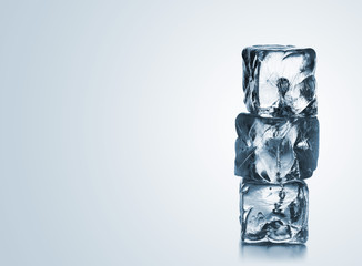Stack of three blue ice cubes with copyspace