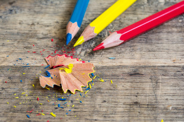 Sharpener and pencil shaves on wood with primary color pencils  © PThira89