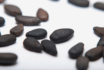 Fototapeta na wymiar Pile of black sesame seeds isolated on white background