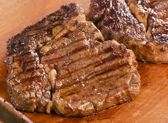 Beef steak on  wooden board.