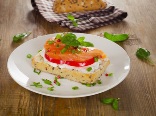 Sandwich with cereals bread and salmon on a old wooden backgroun