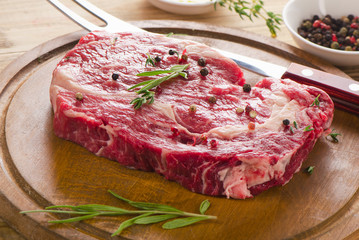 Raw Beef Steak on  wooden  board.