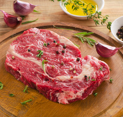 Raw Steak on a  wooden  table.