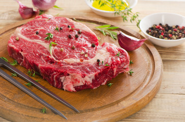 Raw Beef Steak on  wooden  table.