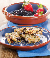 Healthy  granola bars  with fresh berries on a plate.