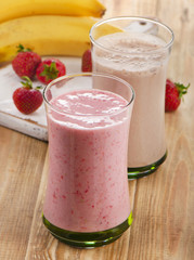 Fruit smoothies with  strawberry and banana on a wooden backgrou