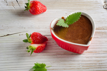 Homemade Chocolate Mousse  in a heart-shaped bowl on wooden tabl