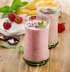 Fruit smoothies with  strawberry and banana on  wooden table.