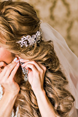 Bride wears earrings