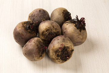 Some beets in a basket over a white background