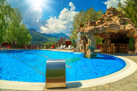 Beautiful swimming pool with beach bar and waterfall