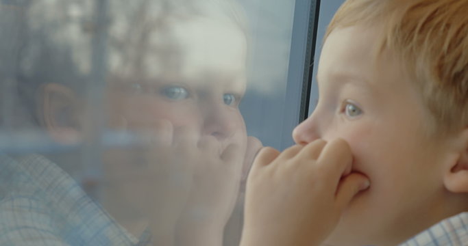 Little child enjoying view from the train window