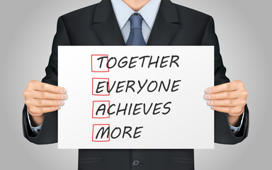 businessman holding Together Everyone Achieves More poster