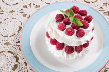 meringue dessert with raspberry and cream. dessert pavlova