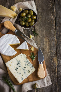 camembert and blue cheese  on wooden cutting board