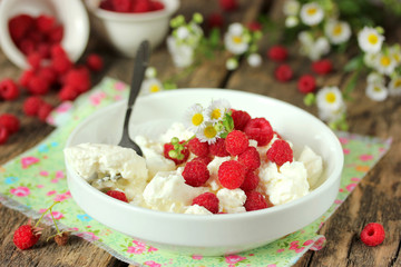 Fresh cottage cheese with fresh raspberries and daisies