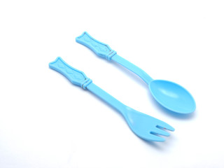 Plastic baby spoon on a white background