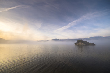 Morning fog over a mountain lake