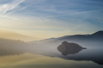 Morning fog over a mountain lake