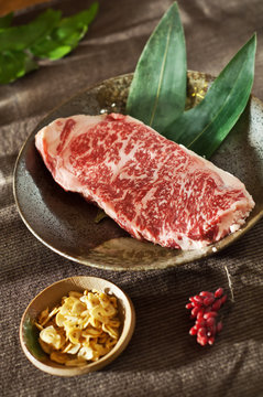 marbled veal Kobe with garlic chips. Raw fresh meat Black Angus Steak. 