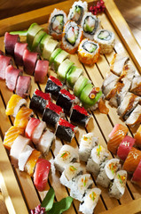 maki sushi set, different kind of sushi rolls on wooden board, Japanese cuisine