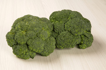 Some green cauliflowers over a wooden surface seen from above