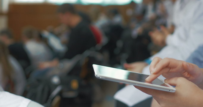 Woman doctor using touch pad on medical conference