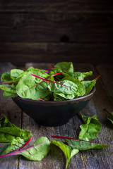 Fresh chard leaves on rustic background