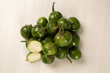 Some green african eggplants over a white background